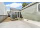 Side view of a backyard with green siding and concrete parking pad at 5 Maranda Holmes St, Charleston, SC 29403