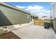 Back view of green house featuring concrete parking pad, green siding, and a wooden fence at 5 Maranda Holmes St, Charleston, SC 29403