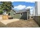 View of backyard with green house siding, new sod, and wood fence at 5 Maranda Holmes St, Charleston, SC 29403