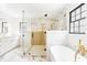 Luxurious bathroom featuring a glass shower, soaking tub, and elegant gold fixtures at 5 Maranda Holmes St, Charleston, SC 29403