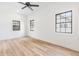 Bright bedroom offering ample natural light through its three windows, enhancing the warm light wood floors at 5 Maranda Holmes St, Charleston, SC 29403