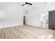 Modern room with ceiling fan shows door to ensuite bath with glass shower at 5 Maranda Holmes St, Charleston, SC 29403