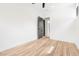 Bright bedroom features light wood floors and a dark interior door that leads to the ensuite bathroom at 5 Maranda Holmes St, Charleston, SC 29403