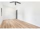 Bright bedroom featuring a ceiling fan, light wood floors, and a dark interior door for a sleek modern style at 5 Maranda Holmes St, Charleston, SC 29403