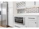Kitchen area with stainless steel appliances, a built-in microwave, wine rack and modern cabinetry at 5 Maranda Holmes St, Charleston, SC 29403