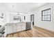 View of the kitchen with a large quartz island, stainless steel appliances, and a view of the living space at 5 Maranda Holmes St, Charleston, SC 29403