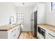 A well-lit kitchen featuring wood countertops, sleek appliances, and a contemporary faucet for modern appeal at 5 Maranda Holmes St, Charleston, SC 29403