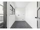 Empty laundry room with black and white tiled floors and door to the outside at 5 Maranda Holmes St, Charleston, SC 29403
