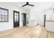 A bright living room showcasing light wood floors, opening up to a stylish kitchen and modern bathroom at 5 Maranda Holmes St, Charleston, SC 29403