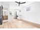 Bright living room with sleek ceiling fan, light wood floors, and access to the stylish kitchen and modern bathroom at 5 Maranda Holmes St, Charleston, SC 29403