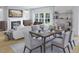 Stylish dining area with a modern table and chairs, open to a living room with a fireplace at 609 Garden Flora Ave, Moncks Corner, SC 29461