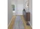 Inviting hallway featuring wood floors, a stylish console table, and a decorative mirror at 609 Garden Flora Ave, Moncks Corner, SC 29461