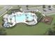 Aerial view of a resort-style pool with palm trees, lounge chairs, and a playground at 609 Garden Flora Ave, Moncks Corner, SC 29461