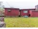 Exterior view of the home with a sprawling backyard, AC unit, and a stone chimney at 609 Levee Dr, Moncks Corner, SC 29461