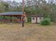 View of backyard outbuildings, including a covered patio and a storage shed at 609 Levee Dr, Moncks Corner, SC 29461