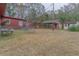 Backyard view of a property with multiple outbuildings, perfect for storage or hobbies at 609 Levee Dr, Moncks Corner, SC 29461