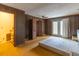 Bedroom featuring wood paneling, ceiling fan, closet, and back patio access at 609 Levee Dr, Moncks Corner, SC 29461