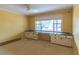 Bedroom with bright yellow walls, large window, and built-in desk needing remodeling at 609 Levee Dr, Moncks Corner, SC 29461