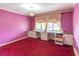 Bedroom with pink walls, red carpet, a window, and desk area needing updates at 609 Levee Dr, Moncks Corner, SC 29461