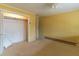 Bedroom featuring yellow walls, carpet, and a closet with bi-fold doors, ready for renovation at 609 Levee Dr, Moncks Corner, SC 29461