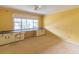 Spacious bedroom with yellow walls, large window, and built-in desk and cabinets waiting for renovation at 609 Levee Dr, Moncks Corner, SC 29461