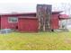 Exterior of home showing a stone chimney, AC unit, and backyard at 609 Levee Dr, Moncks Corner, SC 29461