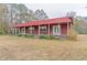 Single-story home with red siding, a metal roof, and a large covered porch at 609 Levee Dr, Moncks Corner, SC 29461