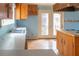 Kitchen featuring blue walls, countertops, and wood cabinets at 609 Levee Dr, Moncks Corner, SC 29461