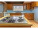 Kitchen highlighting the cooktop and wood cabinets at 609 Levee Dr, Moncks Corner, SC 29461
