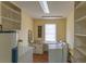 Bright laundry room with washer, dryer, and storage shelves at 609 Levee Dr, Moncks Corner, SC 29461
