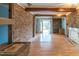 Open living area with wood floors and brick fireplace at 609 Levee Dr, Moncks Corner, SC 29461