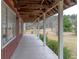 Inviting covered porch with wood floors and support columns at 609 Levee Dr, Moncks Corner, SC 29461