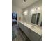 Bathroom with double sink vanity, modern lighting, and grey wood-look flooring at 618 Hilchot Dr, Summerville, SC 29486