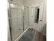 Modern bathroom with a glass-enclosed shower, sleek finishes, and access to the walk-in closet at 618 Hilchot Dr, Summerville, SC 29486