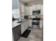 Modern kitchen features stainless steel appliances, white cabinetry, and granite countertops at 618 Hilchot Dr, Summerville, SC 29486