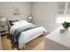 Comfortable bedroom with natural light, wood floors, and a view of the backyard at 7626 Indigo Palms Way, Johns Island, SC 29455
