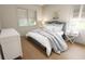 Cozy bedroom featuring natural light, hardwood floors, and stylish furnishings at 7626 Indigo Palms Way, Johns Island, SC 29455