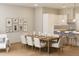 Dining area with decor art, a large dining table, and access to the open-concept kitchen at 7626 Indigo Palms Way, Johns Island, SC 29455