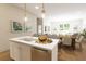 Kitchen island with fruit basket, stainless steel appliances, and pendant lighting at 7626 Indigo Palms Way, Johns Island, SC 29455