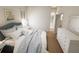 Spacious main bedroom with a king-sized bed, wood flooring, and an ensuite bathroom at 7626 Indigo Palms Way, Johns Island, SC 29455