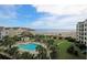 Gorgeous aerial view of resort community pool, residences, and beach access at 8000 Palmetto Dr # 506, Isle of Palms, SC 29451