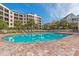 Community pool offering a refreshing escape with lounging areas, surrounded by palm trees at 8000 Palmetto Dr # 506, Isle of Palms, SC 29451
