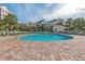 Inviting community pool with lounge chairs, umbrellas, and manicured landscaping at 8000 Palmetto Dr # 506, Isle of Palms, SC 29451