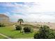 Scenic ocean view with sandy beach, blue umbrellas, and beautiful dunes from elevated lot at 8000 Palmetto Dr # 506, Isle of Palms, SC 29451
