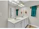 Bathroom featuring double sink vanity, white cabinets, large mirror, and modern lighting at 9009 Cat Tail Pond Rd, Summerville, SC 29485