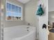 Bathroom featuring a soaking tub with large windows, providing natural light and view at 9009 Cat Tail Pond Rd, Summerville, SC 29485