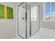 Bathroom featuring a glass-enclosed shower, with chrome hardware and window view at 9009 Cat Tail Pond Rd, Summerville, SC 29485