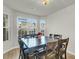 Dining room featuring a large table, modern light fixture, and bright windows at 9009 Cat Tail Pond Rd, Summerville, SC 29485