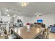 Open dining area with wooden table, bar seating, and a chandelier light fixture at 9009 Cat Tail Pond Rd, Summerville, SC 29485