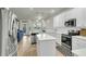 Bright, modern kitchen with white cabinets, stainless steel appliances, and an island at 9009 Cat Tail Pond Rd, Summerville, SC 29485